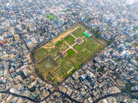Dhaka, Bangladesh - 08 March 2026: Aerial view of Lalbagh Fort surrounded by the dense urban sprawl and colorful rooftops of the old city under bright daylight.