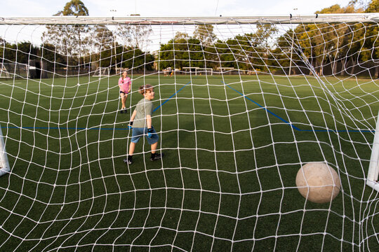 ball hitting the back of the net when kids score in soccer training