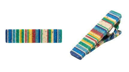 Naklejka premium Sustainable hair clip and accessory crafted from recycled plastic, striped multi-colored design on white background, concept for zero waste fashion and eco-conscious lifestyle products.
