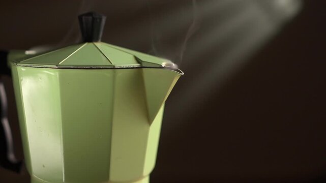 Moka coffee pot with brewing beans, on black background