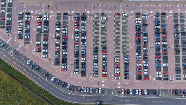 Birmingham, United Kingdom - 21 April 2026: Aerial view of the Amazon EMA4 UXD1 parking lot with rows of colorful cars and organized road markings.