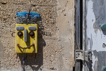 Creative street art piece made of recycled materials on a textured stone wall © elenarostunova