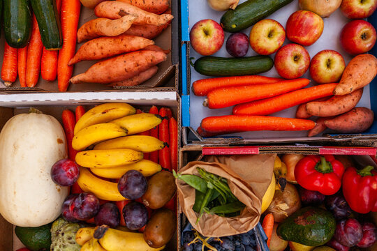 Colourful overhead angle of fresh organic fruit and vegetable boxes at unsupermarket food hub