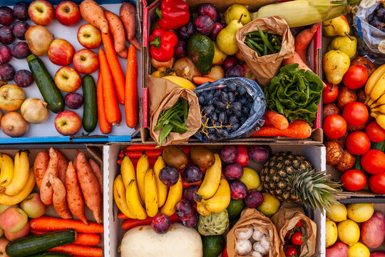 Colourful overhead angle of fresh organic fruit and vegetable boxes at unsupermarket food hub
