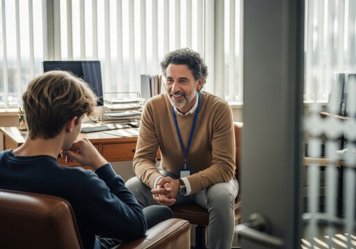 Professional counselor provides guidance to a student during a private meeting in an office.