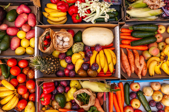 Colourful overhead angle of fresh organic fruit and vegetable boxes at unsupermarket food hub