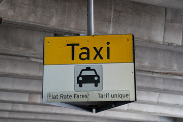 Close up of taxi sign with flat rate fares information. © Erman Gunes