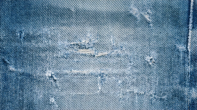 Blue distressed denim texture background with vintage worn wash for casual apparel branding and rugged fashion design 8k resolution no text