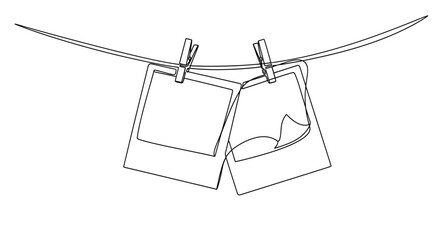 Fototapeta premium Continuous line drawing of two blank instant photos hanging on a rope with clothespins.