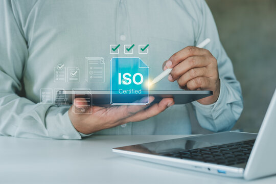 Business professional using tablet with ISO certified interface, quality assurance checklist, compliance verification, corporate standard management, audit process, certification approval workflow