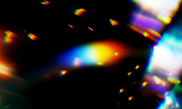 Abstract light refraction creates vivid colorful spectral beams with glowing flares that display a beautiful prismatic dispersion on a dark surface