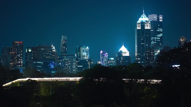Bangkok skyscrapers skyline illuminated at night with modern glass towers, Night cityscape with highrise buildings and glowing urban business district 4k