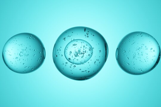 Transparent spheres with bubbles on turquoise background, 3D render