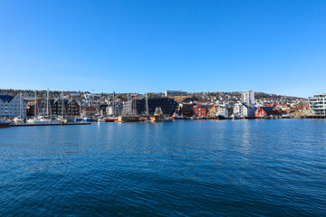Fototapeta premium Waterfront cityscape of Tromsø, Norway with colorful houses and calm Arctic sea