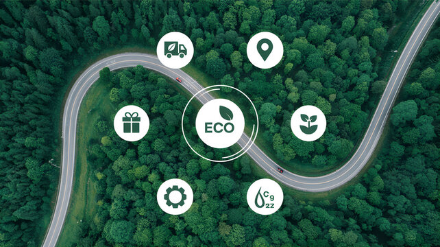 An aerial view of a winding road through a lush forest with eco-friendly icons