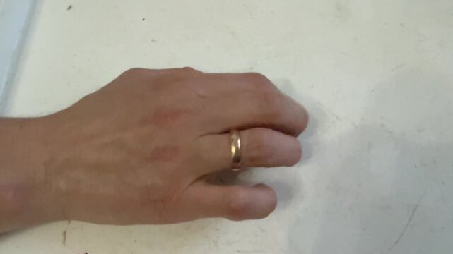Fingers rhythmically tapping on a wooden surface