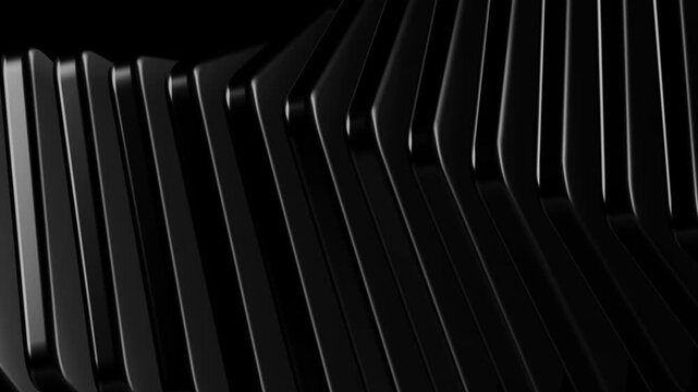 Detailed view of angled black metallic plates with soft lighting on edges illustrating geometric precision and high end architectural design concepts in a dark void