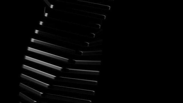 Abstract black geometric sculpture with rotating rectangular plates in a stacked tower formation against a dark studio background with elegant soft lighting
