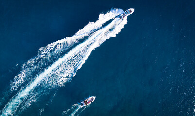 Breathtaking drone shot capturing two white speedboats racing across the deep sapphire waters of Flic en Flac, Mauritius.  © PyngodansPhotography