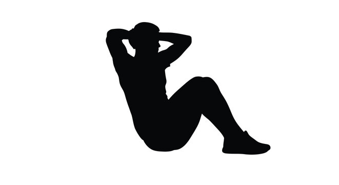 A person performing a sit up exercise in a dark silhouette