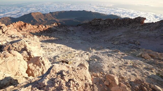 Volcanic landscape with a sea of clouds below teide summit