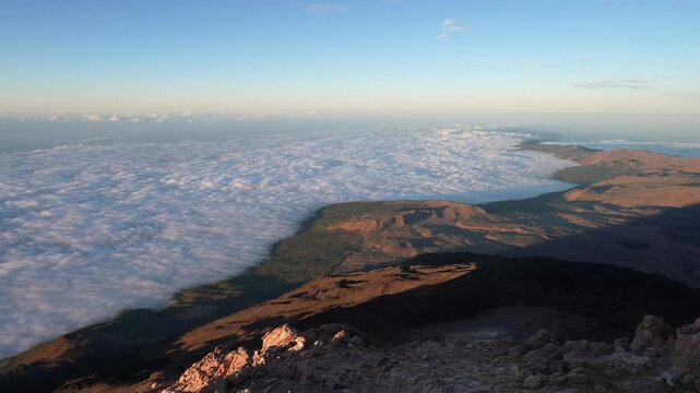 Sunrise view from mountaintop above clouds