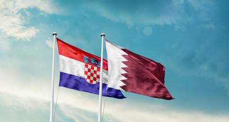 Fototapeta premium Croatia and Qatar friendship flags are waving in the sky. Two country flag for agreement or deal. Croatia Qatar national flag for commitment.