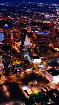 Dazzling panorama of Dallas, Texas, USA at night. Illuminated metropolis scenery from top. Vertical video