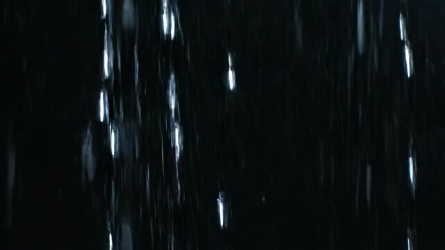 A dramatic dark background with rain falling, evoking a sense of melancholy or solitude.