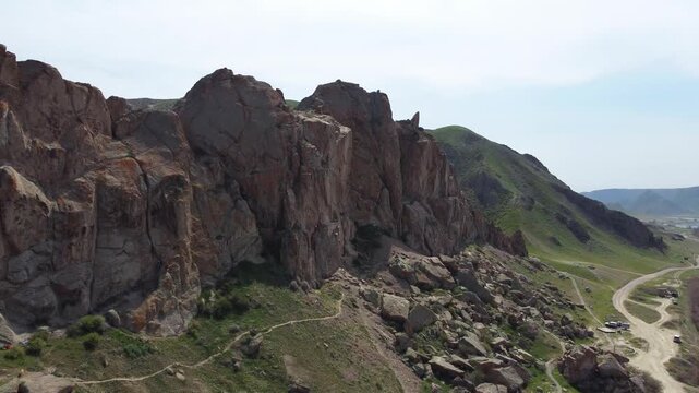 Aerial 4K view of Ili River and sacred Tamgaly Tas petroglyphs in Kazakhstan steppe