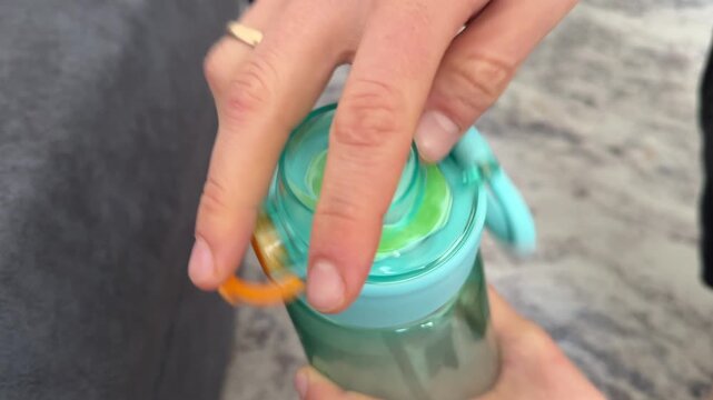Hand opening turquoise water bottle lid