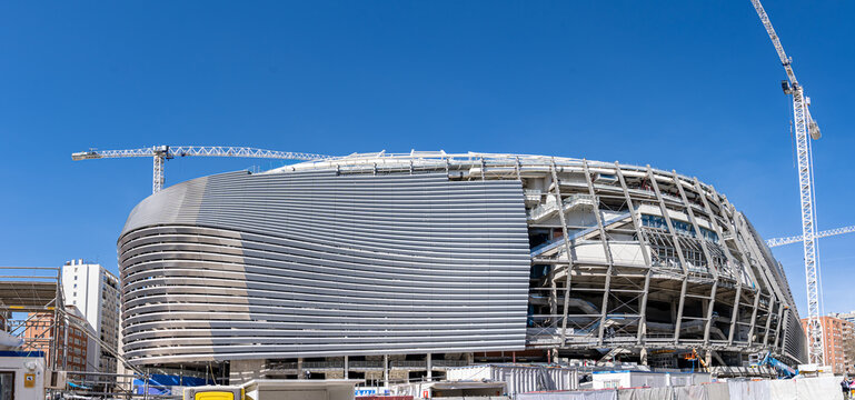 March 15, 2023. Madrid, Spain. Exterior view of Santiago Bernabeu Stadium during major construction and renovation works with cranes and structural elements visible.