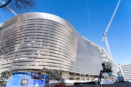 March 15, 2023. Madrid, Spain. Exterior view of Santiago Bernabeu Stadium during major construction and renovation works with cranes and structural elements visible.