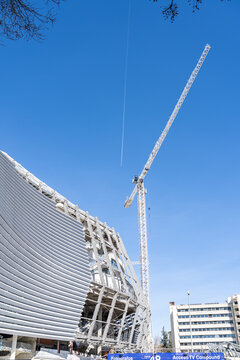 March 15, 2023. Madrid, Spain. Exterior view of Santiago Bernabeu Stadium during major construction and renovation works with cranes and structural elements visible.
