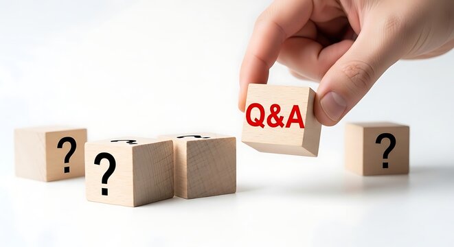 Hand placing a Q&A block among question mark blocks on a white background.