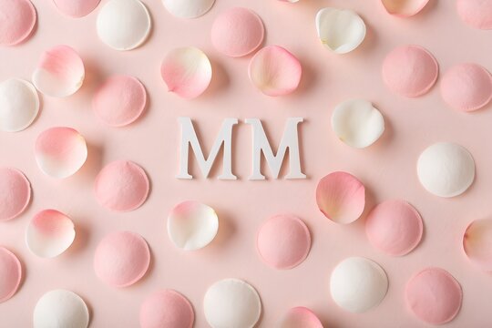 Pastel pink and white petal arrangement with 'm' lettering