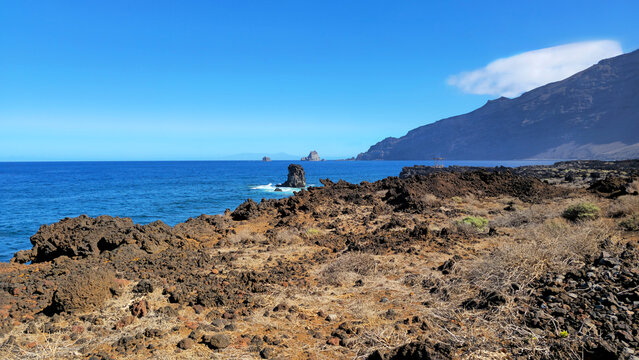 West coastline landscape displaying rock formations and mountain range, Island El Hierro, Canary Islands, Spain, Europe.