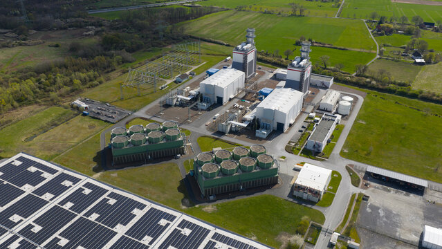 Hamm, Germany: Aerial view of Trianel Gaskraftwerk Hamm GmbH Co. KG, a gas-fired power plant with cooling towers and industrial buildings surrounded by green fields.