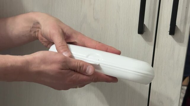Opening and closing a small white plastic case with a lid