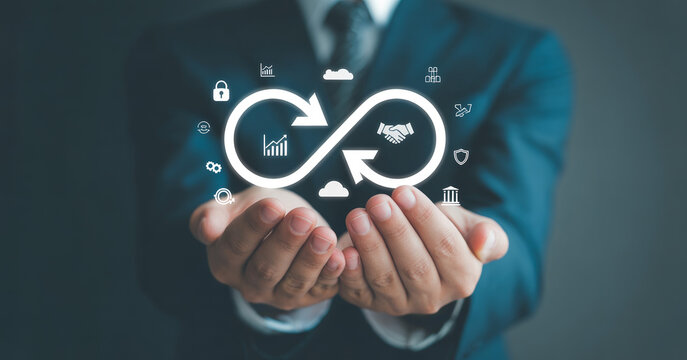 Businessman hands showing infinite loop symbol for continuous improvement and business cycle.