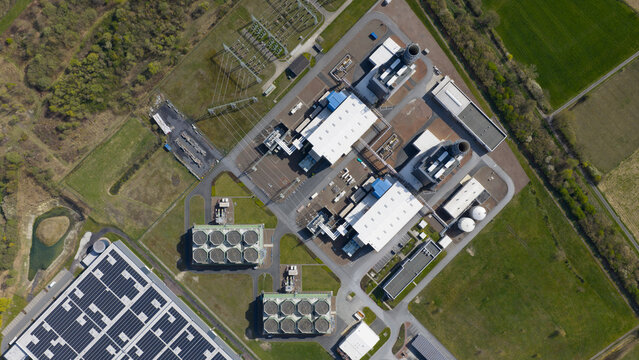 Hamm, Germany: Aerial view of Trianel Gaskraftwerk Hamm GmbH Co. KG, a gas-fired power plant with cooling towers and industrial buildings surrounded by green fields.