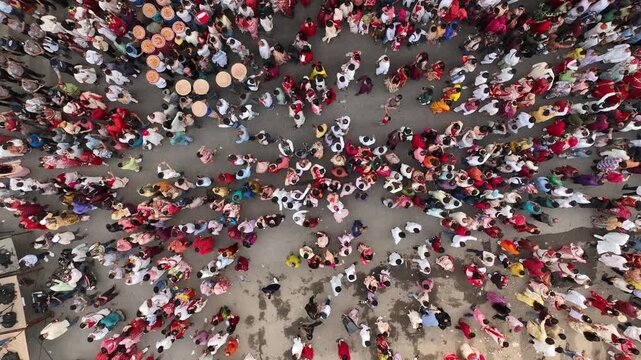 
A kaleidoscope of red and white as a joyous crowd gathers in a circular embrace to welcome the Bengali New Year.