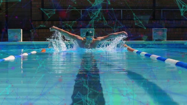 Male swimmer starting breath and pushing in lane, timing fly stroke, creating splash for training