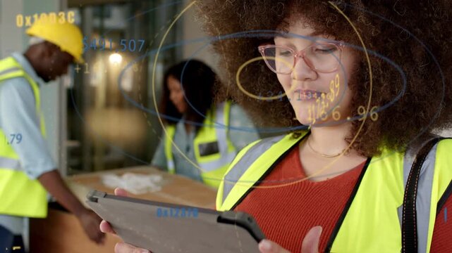 Construction lead tapping tablet and activating HUD while team checking box and verifying shipment