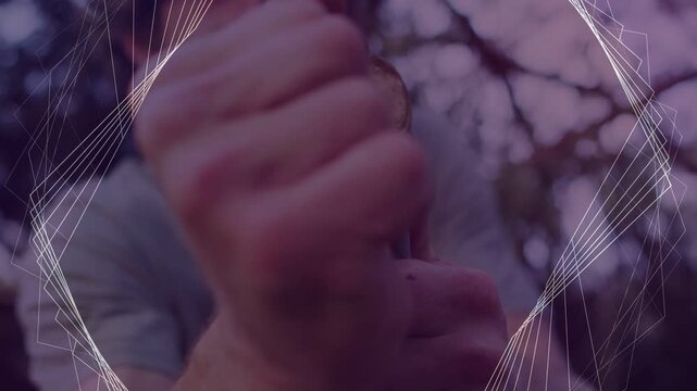 Man gripping stick and pulling cord while rotating and knotting, crafting, overlay framing hands