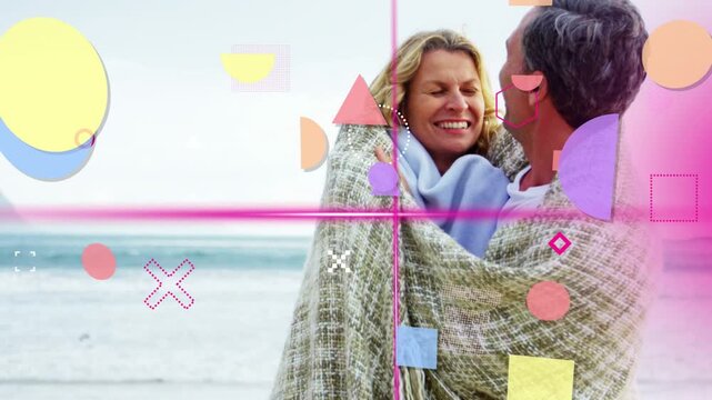Cam revealing couple wrapping blanket at shore for warmth, pastel shapes crossing faces, marketing
