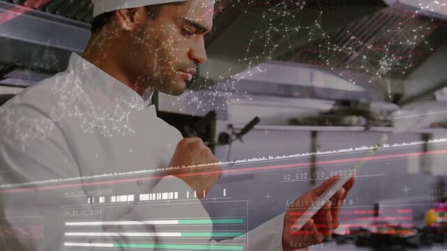 Male chef tapping tablet and causing faint data HUD to update while monitoring kitchen operations