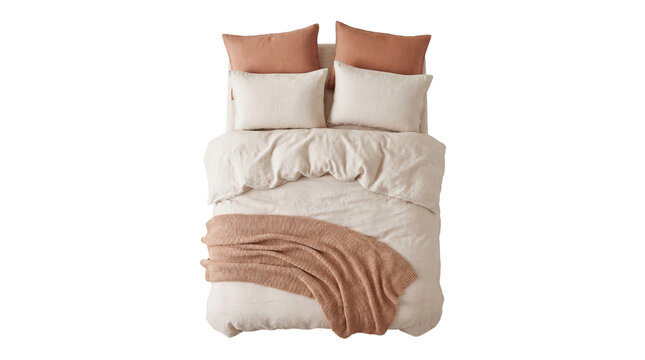 Cozy bedroom scene featuring a neatly made bed with textured linen bedding, pastel accent pillows, and a folded throw blanket for a comfortable and inviting atmosphere