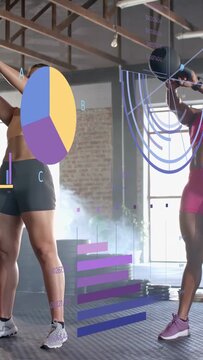 Vertical video: Two women driving hips, swinging KBs to shoulder in gym training, data overlaying