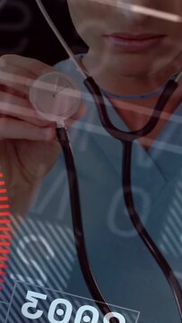 Vertical video: Doctor moving stethoscope forward, causing medical HUD red vitals shifting for exam